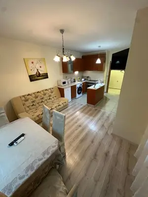 a living room with a couch and a table at Apartment near the sea in Pomorie