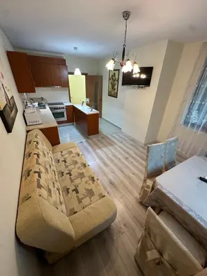 a living room with a couch and a kitchen at Apartment near the sea in Pomorie