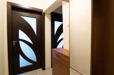 a room with a door and a dresser with a mirror at Relax in Lazur - Georgi Baev Str in Burgas City