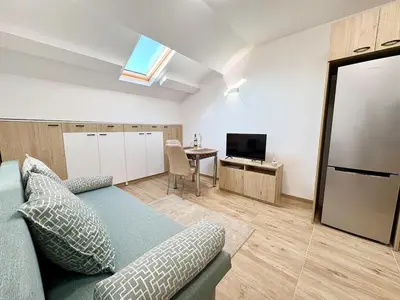 a living room with a couch and a table at Skyline Loft in Varna City
