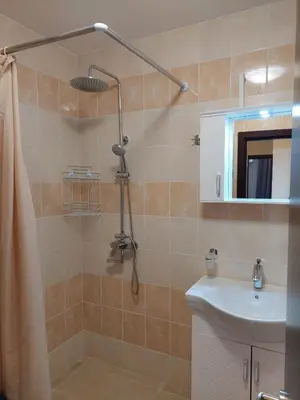 a bathroom with a shower and a sink at Апартаменти Делукс 2 in Burgas City
