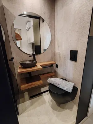 a bathroom with a sink and a mirror at SOHO apartments in Burgas City
