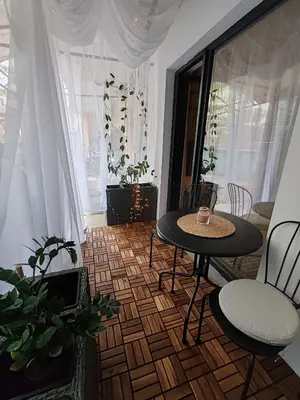 a living room with a table and chairs and a window at SOHO apartments in Burgas City