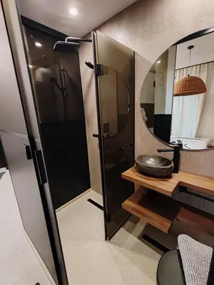 a bathroom with a shower and a sink and a mirror at SOHO apartments in Burgas City