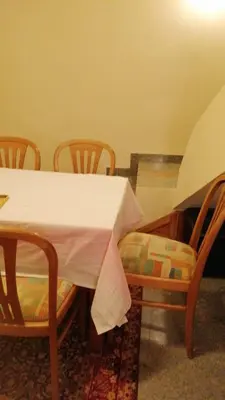 a dining room table and chairs with a tablecloth on it at Апартамент опера in Varna City