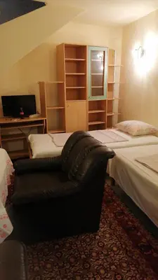 a bedroom with two beds and a couch in it at Апартамент опера in Varna City
