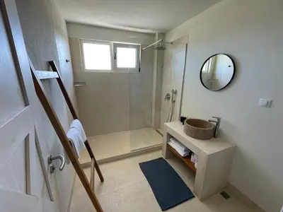 a bathroom with a shower and a sink and a mirror at Lozenets Luxury Pool Villa by Lozenetsvillas in Lozenets