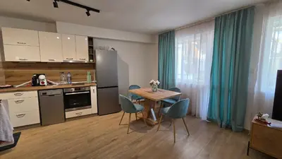 a kitchen with a table and chairs and a table and a kitchen with a kitchen at Atelier Pepi in Varna City