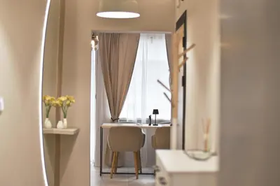 a room with a table and chairs and a window at Boutique 2-Bedroom Apartment Downtown Burgas in Burgas City
