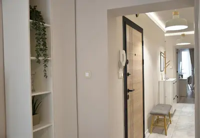 a hallway with a door leading into a room at Boutique 2-Bedroom Apartment Downtown Burgas in Burgas City