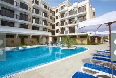 a swimming pool in front of a building at Villa Valencja Apartments Family in Sunny Beach