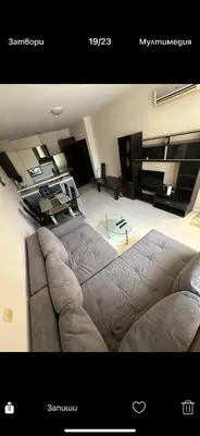 a living room with a couch and a table at Апартаменти Нино 1 in Sozopol