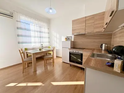 a kitchen with a table and a dining room at SeaSide 2BR Central apartment in Varna City