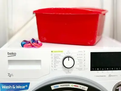 a red bucket sitting on top of a washing machine at SeaSide 2BR Central apartment in Varna City