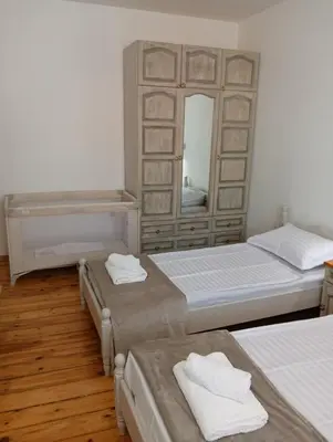 a bedroom with two beds and a mirror at Guest Rooms Ilko in Varna City