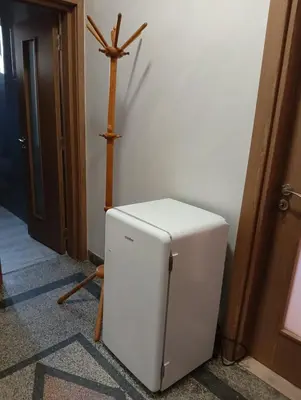 a white refrigerator in a room with a cross on the wall at Guest Rooms Ilko in Varna City