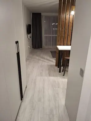 an empty room with a hallway with a table at Yana Sanny Beach in Sunny Beach