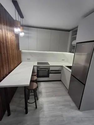 a kitchen with a table and a refrigerator at Yana Sanny Beach in Sunny Beach