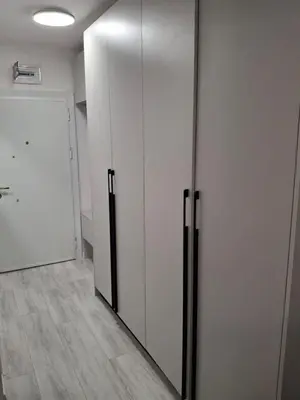 a room with a closet with white cabinets and a door at Yana Sanny Beach in Sunny Beach