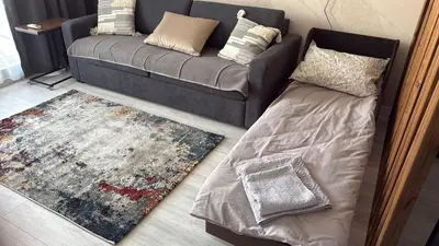 a living room with a couch and a rug at Yana Sanny Beach in Sunny Beach