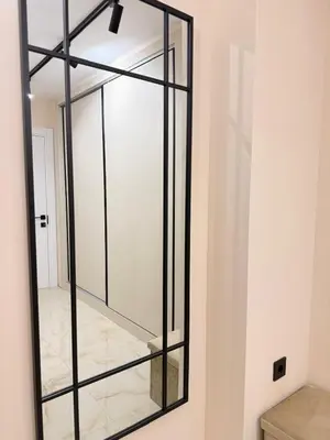a glass mirror on a wall in a room at Seaside Home in Burgas City