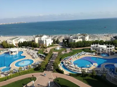 an aerial view of a resort with two pools at Двуспален апартамент Сънсет ризорт с фронтален изглед към море in Pomorie