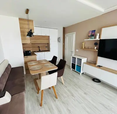 a living room with a table and a couch at Apartment for guests Panorama - first line sea in Burgas City