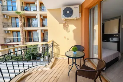 a balcony with a table and chairs and a bed at Harmony Suites 2 Private Studio 219 in Sunny Beach