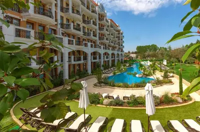 an exterior view of a hotel with a swimming pool at Harmony Grand Resort 16 Private Apartment 214 in Sunny Beach