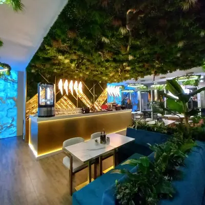 a restaurant with a table and chairs and a bar at Harmony Grand Resort 16 Private Apartment 214 in Sunny Beach