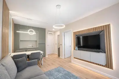 a living room with a large flat screen tv at Harmony Grand Resort 16 Private Apartment 214 in Sunny Beach