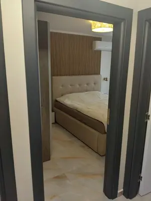 a view of a bedroom with a bed in a room at Emperium, Style, Coziness and tranquility by the sea in Sveti Vlas! in Sveti Vlas