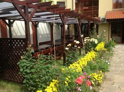 a garden of flowers in front of a building at Апартамент Park & Sea Retreat in Obzor