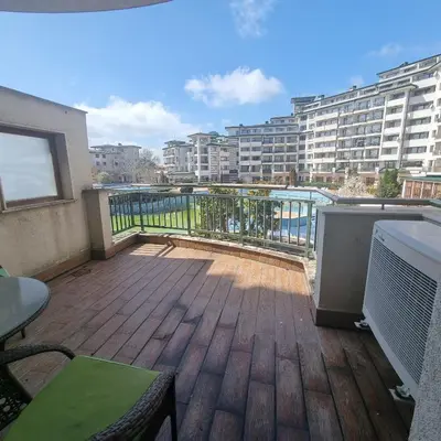 a balcony with a view of a building at Emerald Beach Resort & Spa, Apartment S105 in Ravda