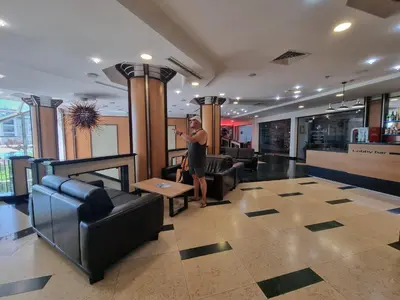 a man standing in the lobby of a hotel at Emerald Beach Resort & Spa, Apartment S105 in Ravda