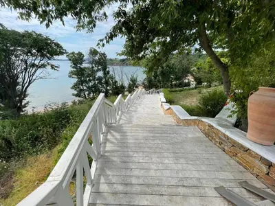 a stairway leading down to the water with a tree at Valena Royal apartment in Chernomorets