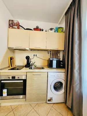 a small kitchen with a sink and a washing machine at Spacious apartment with 2 bedrooms and 2 bathrooms complex ROYAL SUN Sunny beach in Sunny Beach