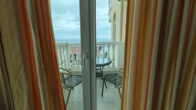 a view of a balcony with a table and chairs at Marina Sunrise Complex by the sea in Sveti Vlas