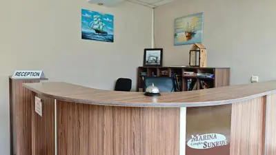a wooden podium in a room with a desk at Marina Sunrise Complex by the sea in Sveti Vlas