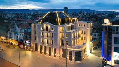 a large white building with a gold dome on top of it at Central Luxury One Bedroom in Varna in Varna City