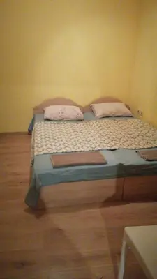 a bed in a room with two pillows on it at Апартамент 27 юли 1 in Varna City
