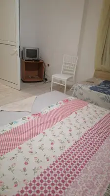 a bedroom with a bed with a red and white blanket at Апартамент 27 юли 1 in Varna City