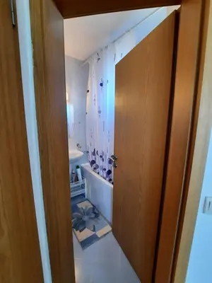 a bathroom with a sink and a toilet and a door at Villa Jasmin in Aheloy