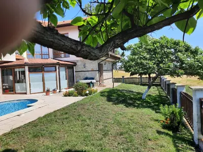 a house with a tree and a swimming pool at Villa Jasmin in Aheloy