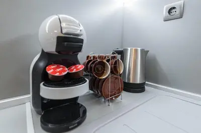a coffee maker sitting on a kitchen counter with cups at Calm space in Varna top center in Varna City