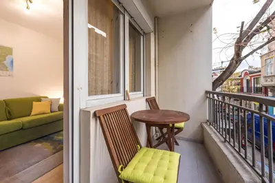 a small balcony with a table and a couch at Calm space in Varna top center in Varna City
