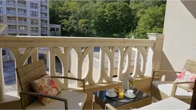 a balcony with chairs and a table on a balcony at Above the Sea Luxury Apartment in Varna City