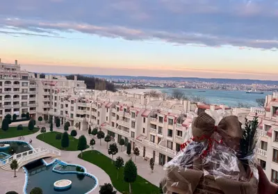 a person is looking out from a building at Above the Sea Luxury Apartment in Varna City
