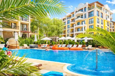 a pool at a hotel with chairs and umbrellas at Harmony Suites 2 Private Studio 409 in Sunny Beach