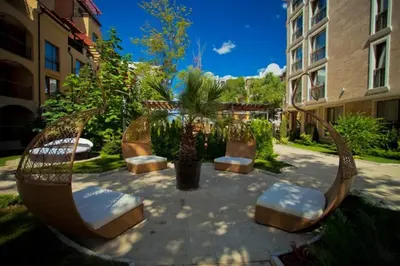 a circular patio with chairs and trees and buildings at Harmony Suites 2 Private Studio 409 in Sunny Beach